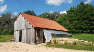 south-view-today Last fall we got polycarbonate panels on the greenhouse roof. Still have to finish the door this summer. Check out that copper-colored metal roof.