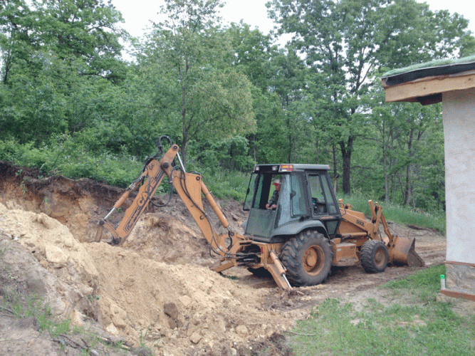 Yet more digging into our hill to create a root cellar.