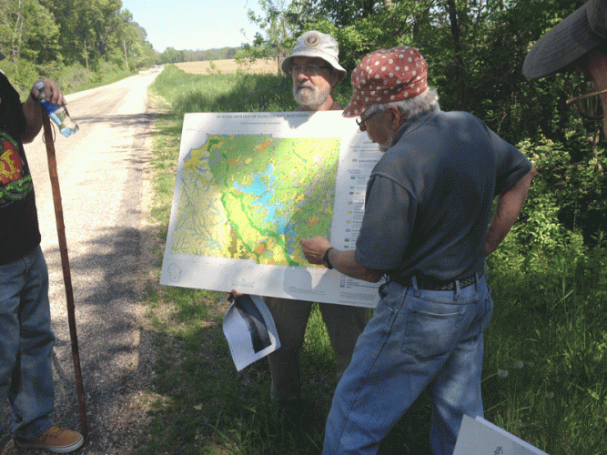 Gary Werner holds a map while Dr. David Mickelson describes the geology of the trail.