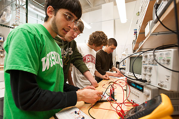 Students (from left to right) Andrew Dias, Jeremy Schaefer, Andrew Bremer and Jeremy Glynn work together to create a low-cost spirometer in the Engineering Centers Building at the University of Wisconsin-Madison on March 11, 2009. The device is used to measure lung function and could be used in low-income countries to diagnose and manage respiratory disease. The work is part of a Biomedical Engineering Design class project designed by postdoctoral fellow David Van Sickle.