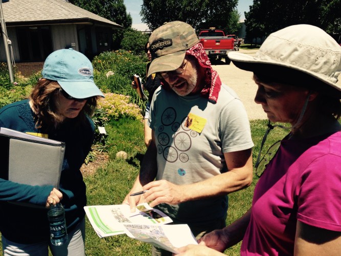 Doug and two classmates getting hands-on experience at the Ag Station.
